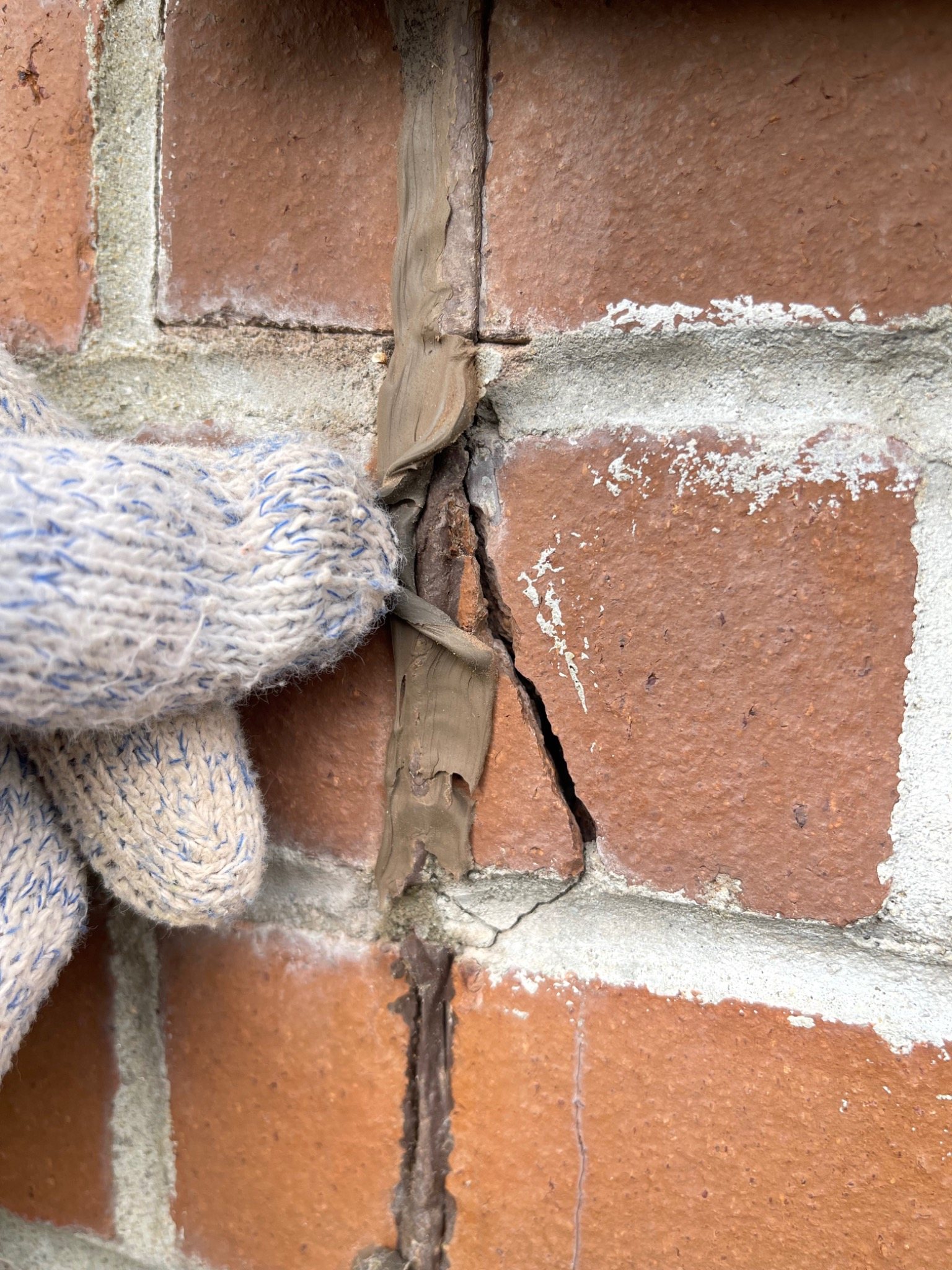 Brick masonry movement joint at a commercial opening showing an incomplete joint condition