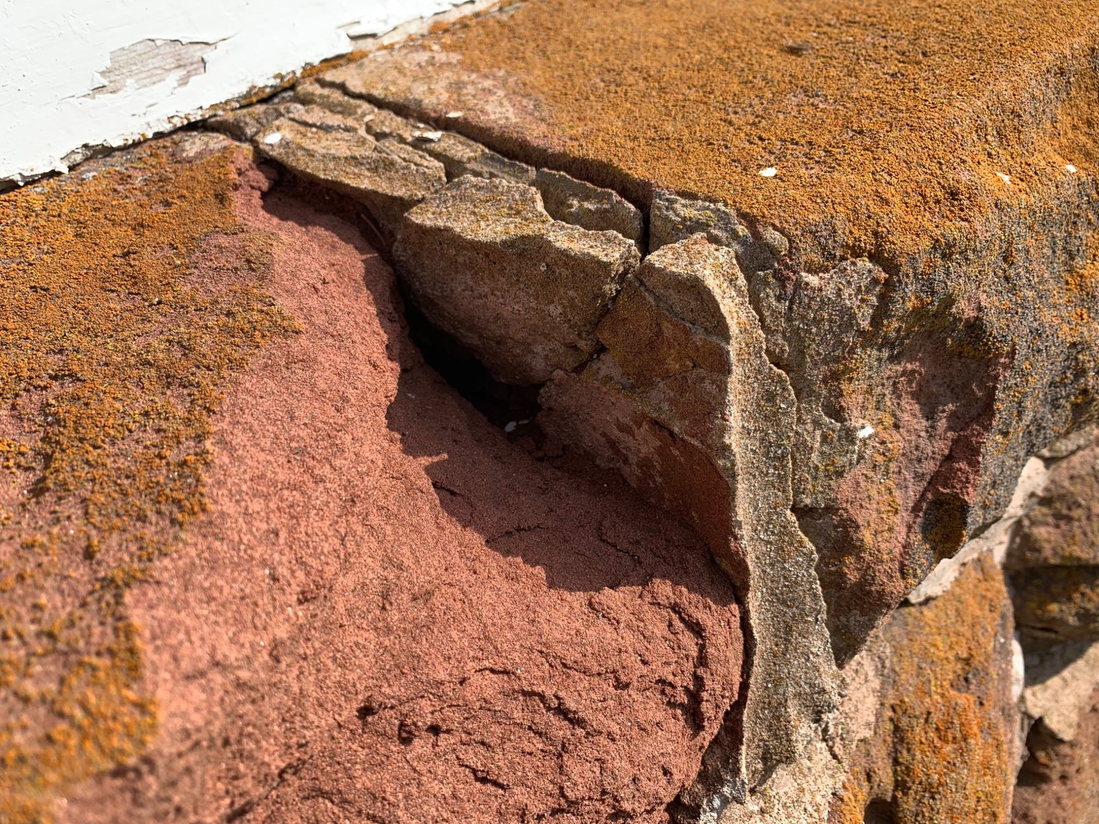 Soft historic sandstone showing weathered surface loss and vulnerability to aggressive treatment
