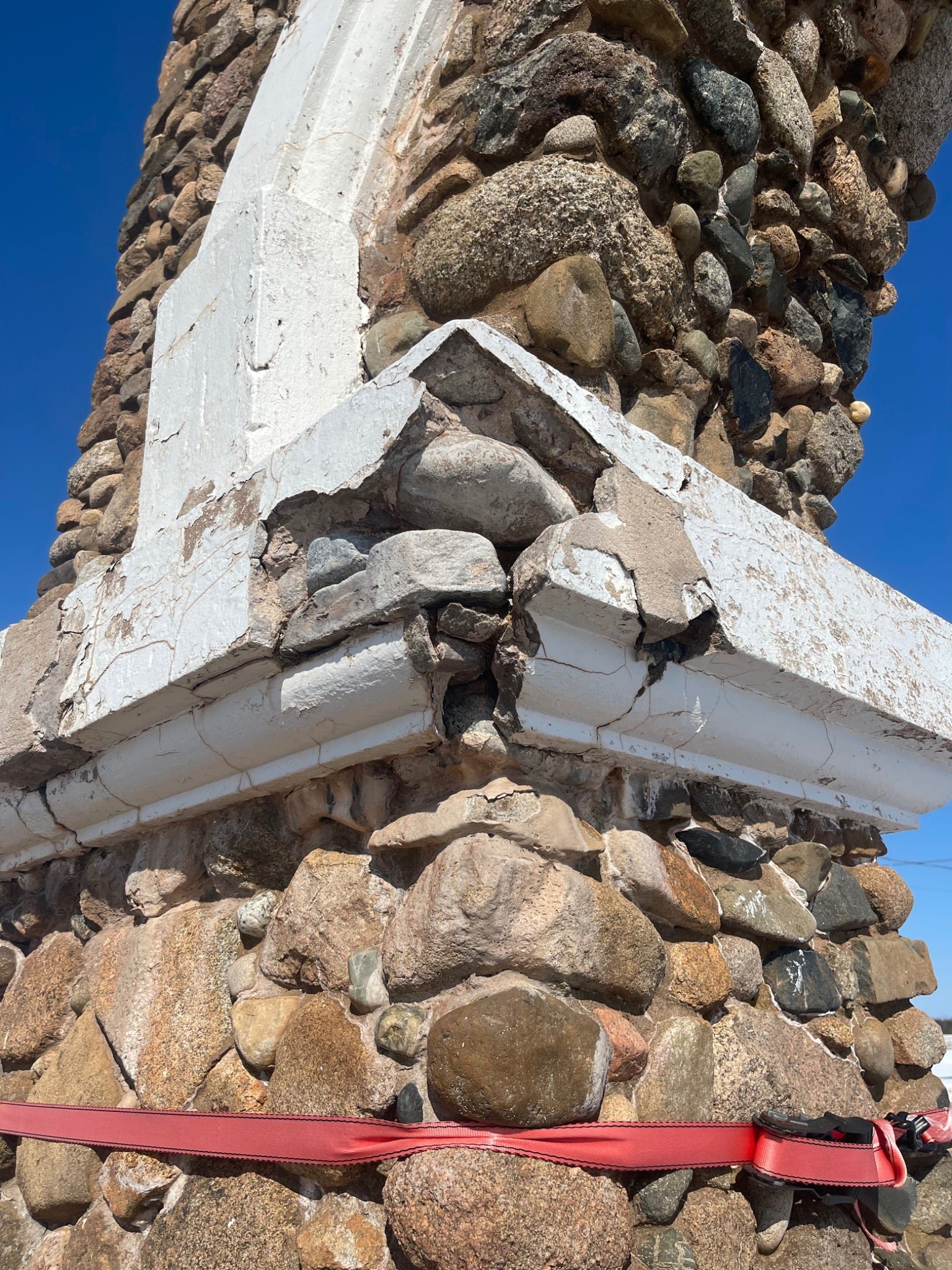 Historic stone corner at Mont-Carmel being supported and rebuilt during masonry restoration