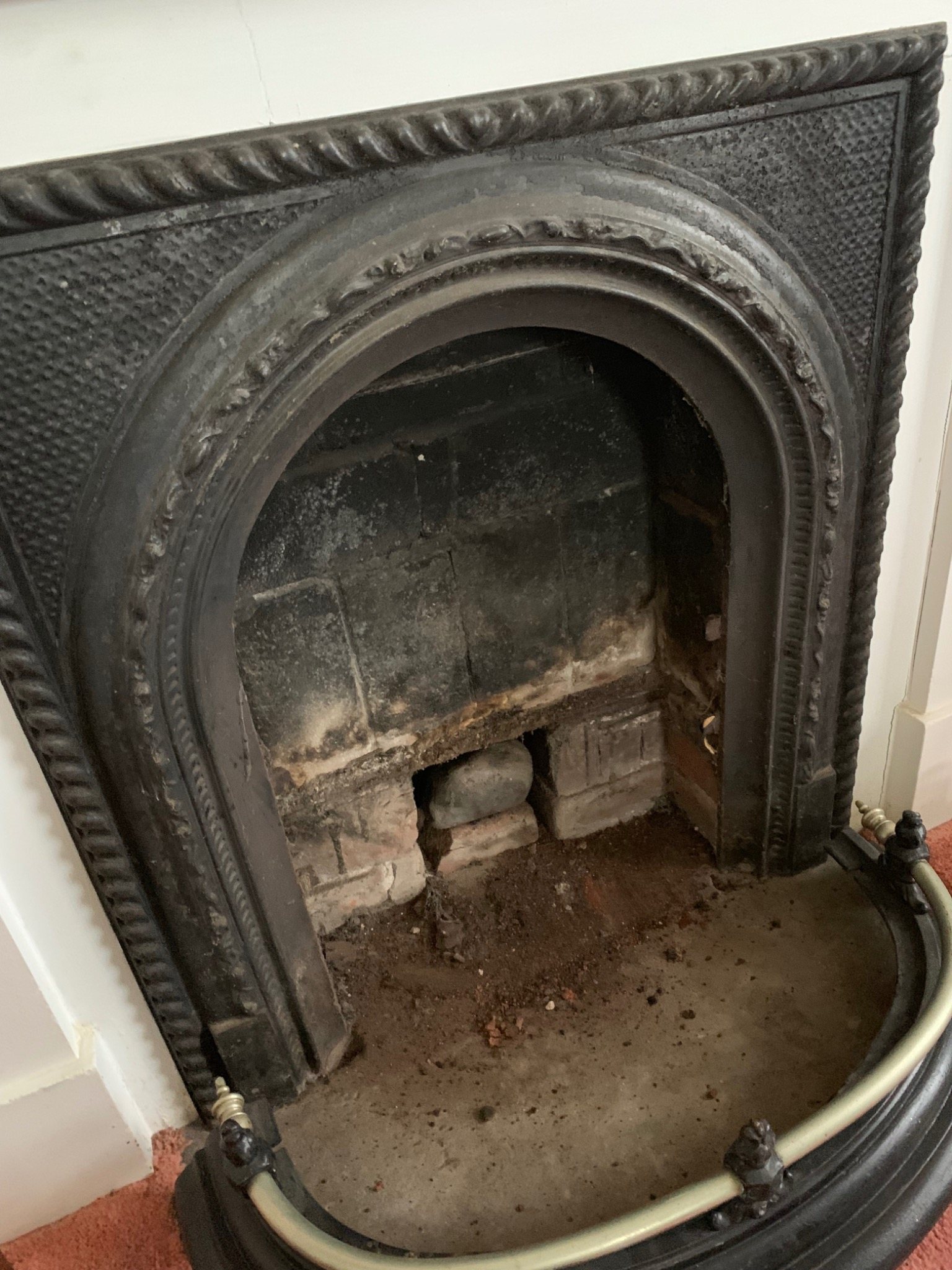 Historic cast iron fireplace and brick masonry showing original character