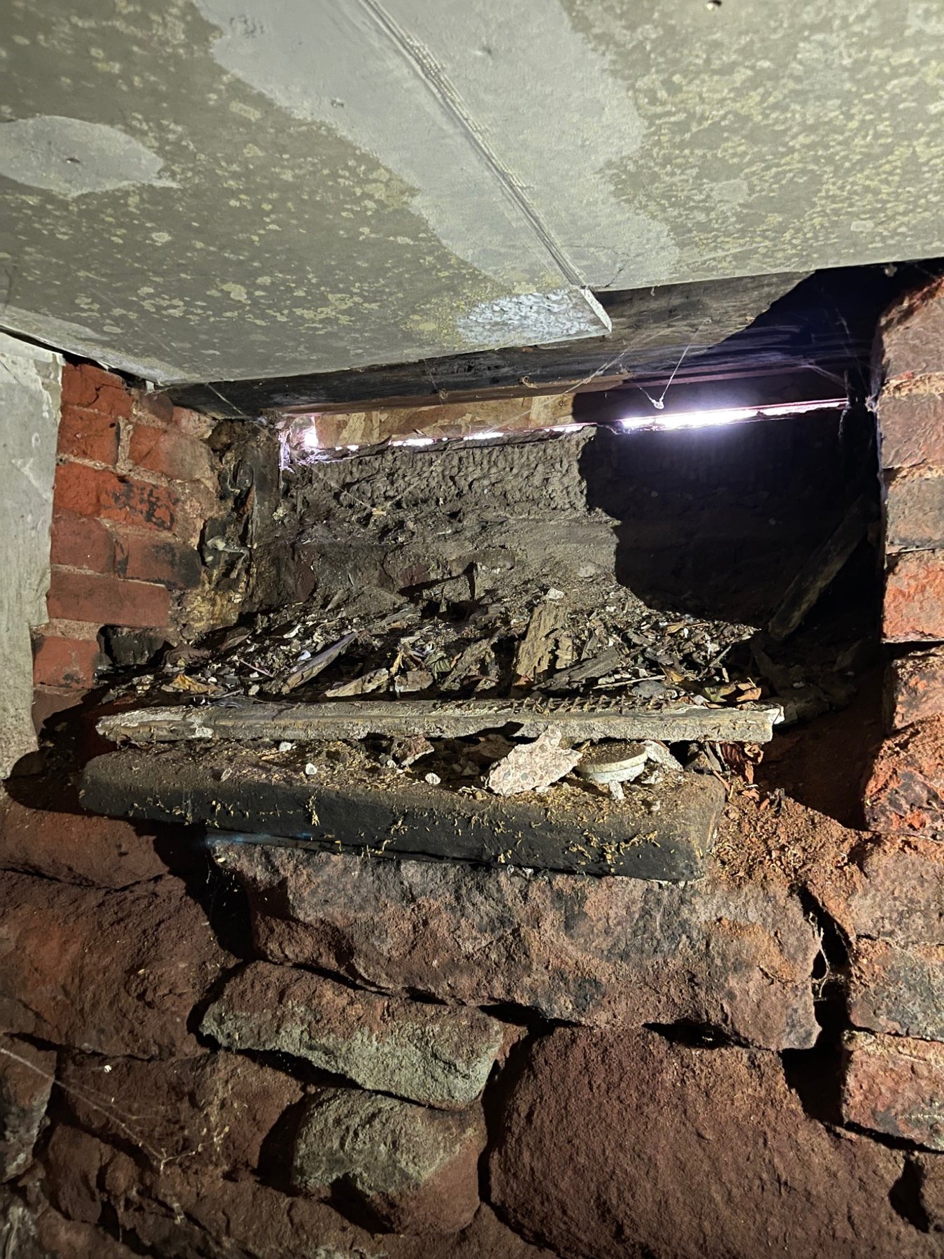 Old stone foundation with deep mortar loss and internal voids