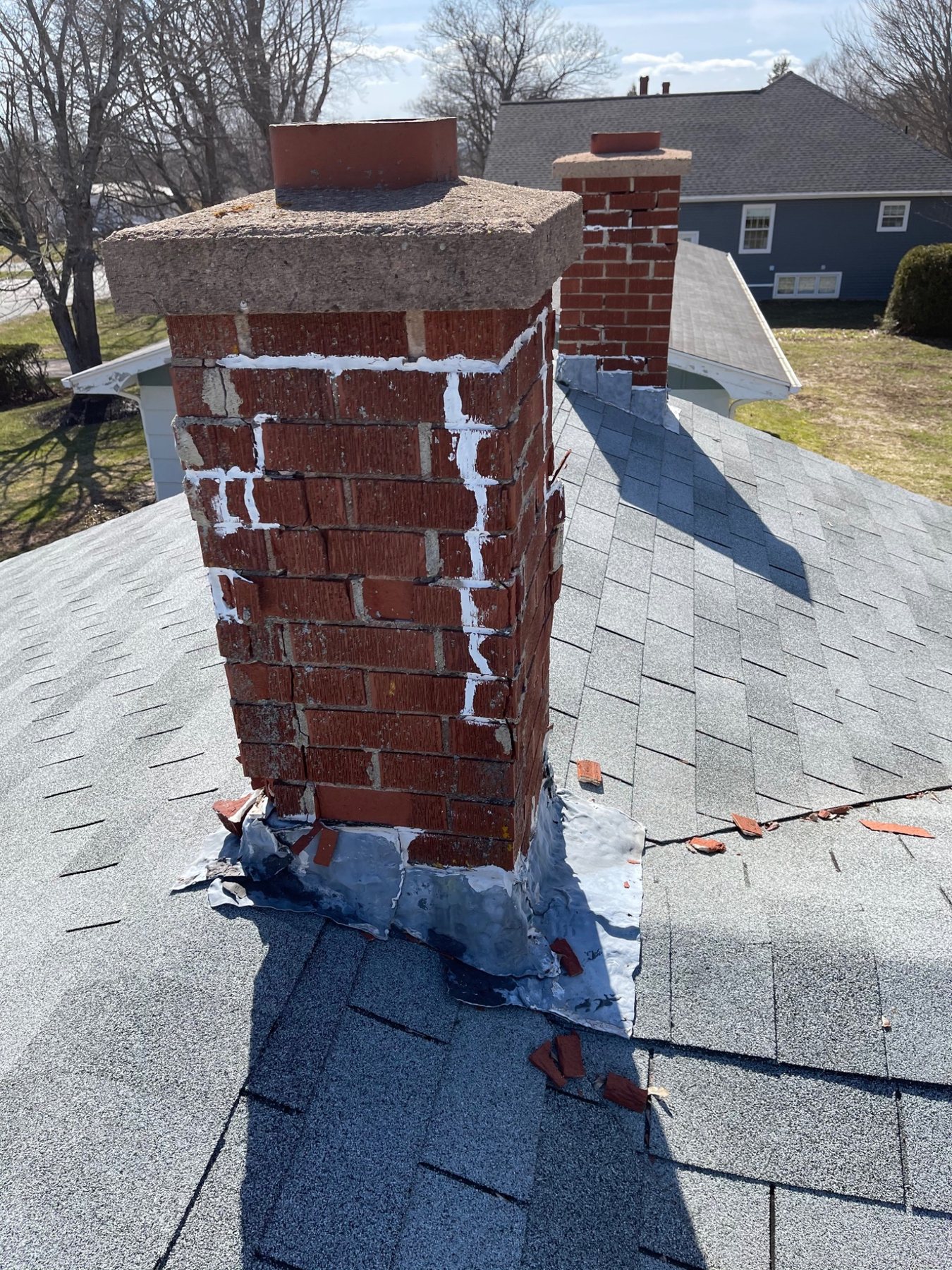 Previous shallow masonry patching illustrating the limits of face-only mortar repair